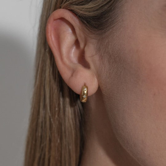 Crystal cosmic huggie earrings - gold