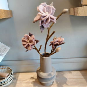 Magnolia branch with dusty rose flowers