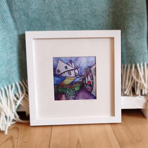 Tudor building & market print in a frame