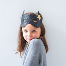 Load image into Gallery viewer, Channel her inner superhero with this fabulously glittery bat mask!  Made from the chunkiest, sparkliest black glitter and with a lovely gold star detail, this super-cool elasticated mask will be sure to make her stand out from the crowd! 
