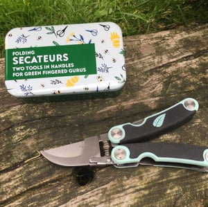 Folding secateurs in a tin