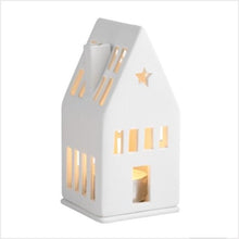 Load image into Gallery viewer, Handmade from unglazed porcelain, this wonderful mini light house is a lovely decorative element to any home.  When a simple tealight is placed inside, it creates a cozy atmosphere in the evening - its door and windows which are cut out by hand, allow delicate candlelight to shine through.

