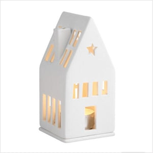 Handmade from unglazed porcelain, this wonderful mini light house is a lovely decorative element to any home.  When a simple tealight is placed inside, it creates a cozy atmosphere in the evening - its door and windows which are cut out by hand, allow delicate candlelight to shine through.